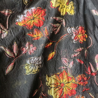 Tissu jacquard brodé en organza transparent métallisé, motif floral embossé dégradé noir, léger (69 g/m²), pour robe de soirée.