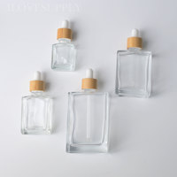 Flacon compte-gouttes carré en verre transparent de 15 ml, 30 ml, 50 ml, 100 ml avec bouchon en bambou naturel, rechargeable, pour huiles, ensembles écologiques en gros
