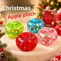 Jouet souple translucide Pomme de Noël avec tige courte et feuille supérieure, finition brillante transparente avec flocons et paillettes à l'intérieur, anti-stress