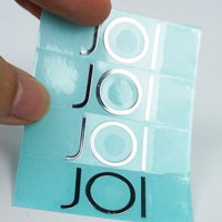 Autocollants en vinyle imperméables personnalisés avec logo UV pour l'emballage de parfums et de rouges à lèvres, autocollants adhésifs transparents argentés bronzés