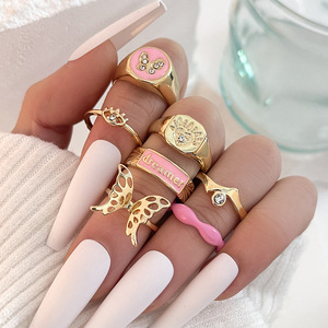 ZL-173 Kit de Joyería para Mujer, Anillos de Aleación Dorada con Cristales, Diamantes de Imitación y Esmalte en Forma de Ojo de Mariposa y Corazón, 7 Piezas - Product Image 1