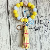 Beliebtes Modisches Vielseitiges Armband Leder-Quastenanhänger Autoschlüsselringe Handgefertigte Bonbonfarbene Silikonperlen Handgelenk-Schlüsselanhänger