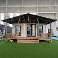 Maison conteneur extensible avec porche couvert, 20 pieds, cadre noir, toit à pignon, fenêtres en treillis, clé en main pour location de vacances