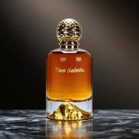 Flacon de parfum de luxe en verre transparent de 100 ml avec base en forme de montagne dorée et bouchon texturé pour emballage de marque