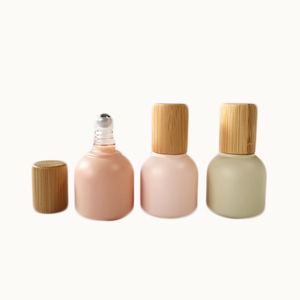 New Design high-end essential oils bottle 10ml morandi color round shape glass roll on bottle with metal roller and bamboo lid