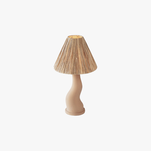 Lampe de table en céramique beige rustique, avec un abat-jour en raphia plissé et une base ondulée minimaliste de style balinais. - Product Image 1