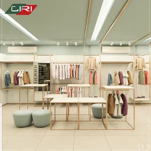 Tienda de ropa Diseño de decoración de interiores Muebles de exhibición de pared para ropa Mostrador de tienda de ropa con mesa de embalaje