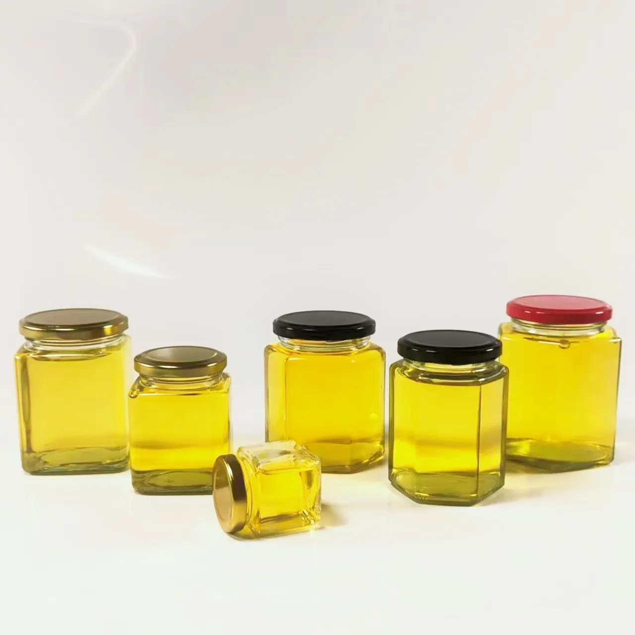 Customized 250ml 500ml hexagonal glass sealed honey packaging bottle with nut, unique empty glass jar for holding honey