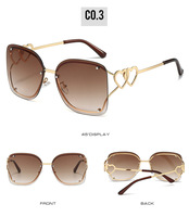 Lunettes de soleil de luxe pour femmes, monture métallique sans cadre, style Y2K2025, dégradé, lunettes en forme de cœur chromées
