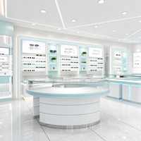 Vitrine de magasin d'optique en verre blanc avec pieds en tube doré, barre lumineuse et protection en verre, certifiée CE ETL pour opticien