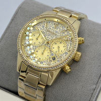 Montre chronographe de luxe pour femmes MKOriginals en acier inoxydable doré, avec lunette pavée de cristaux, aiguilles, étanche, fermoir pliant