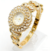 Jam Tangan Wanita Warna Emas dengan Dial Putih Bulat, Bezel Kristal Marquise Sunburst, dan Gelang Bertabur Kristal