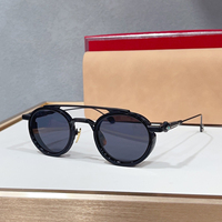 Lunettes de soleil unisexes rétro rondes de luxe, monture noire à double pont, protection UV400, idéales pour la conduite, les voyages et les soirées.