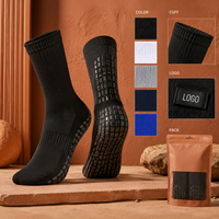 Chaussettes de football renforcées noires mi-mollet avec coussinets internes et externes pour une adhérence optimale sur le terrain, profil mince, adaptées aux crampons, avec tableau de tailles