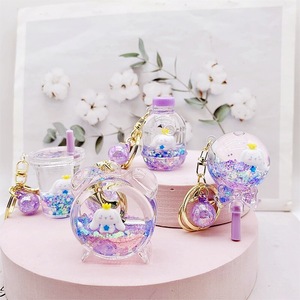 Porte-clés en acrylique avec liquide et <span class=keywords><strong>sable</strong></span>, motif Cinnamoroll chien bleu aux grandes oreilles, jouet en peluche flottant, petit pendentif dessin animé mignon irrégulier - Product Image 1
