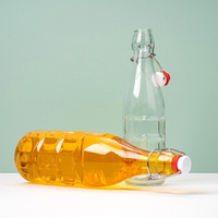 Bouteille en verre transparente de 1 litre avec couvercle à clapet en métal pour jus pressé à froid, kombucha et stockage de boissons fermentées
