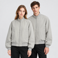Blouson Bomber Unisexe Hydrofuge Col Montant Fermeture Éclair Manches et Ourlet Côtelés Coupe Ample Vêtement d'Extérieur Décontracté Vente en Gros