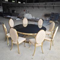 Table de bar ronde avec plateau en verre noir et base en grille en acier inoxydable doré