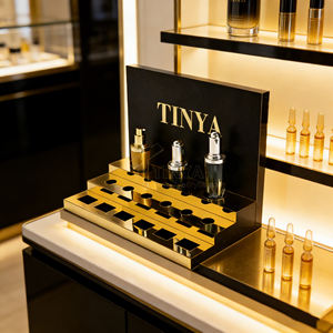 Support de soin de la peau de bureau en acrylique au design personnalisé Tinya, support de crème pour les <span class=keywords><strong>yeux</strong></span> de luxe, noir et or, marque haut de gamme, présentoir de magasin de beauté - Product Image 1
