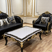 Ensemble de canapés noirs capitonnés de style baroque royal européen haut de gamme pour salon de villa de luxe avec sculptures dorées ornées