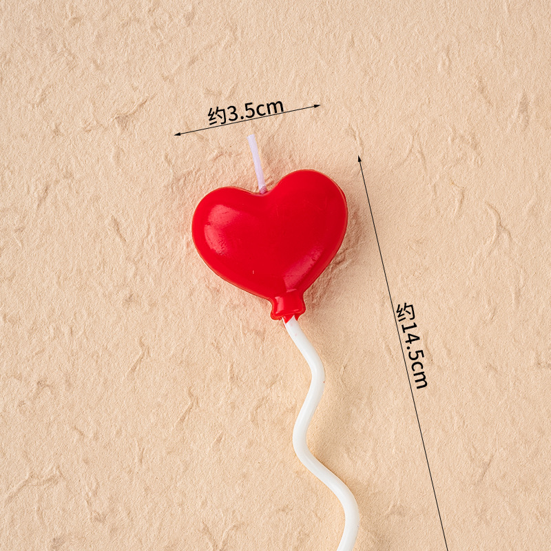 Red heart-shaped balloon candle