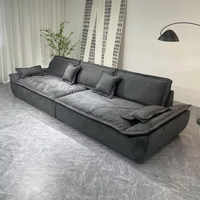Canapé modulaire en tissu anthracite deux places en forme de L avec assise profonde, coussins d'accoudoir et dossier pour salon, villa, espace lounge contemporain