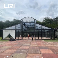 Tentes de réception de luxe pour 100 invités, avec structure noire circulaire, en verre, type serre, marquise, orangerie ou atrium, pour mariages et événements