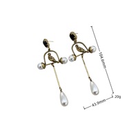 Boucles d'oreilles rétro exagérées en forme de cage à oiseaux dorée avec perles