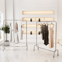 Présentoirs suspendus pour magasin de vêtements ronds en acier inoxydable, haute qualité, prix de gros, 2023