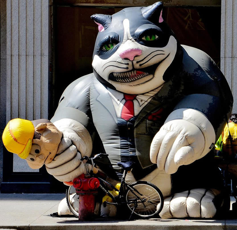 Giant Inflatable Cat with Construction Worker and Money Bag in