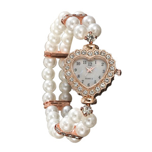 Stylish <b>watch</b> featuring a heart-shaped dial fully set with rhinestones and pearls, a petite strap, and a beautiful double-row pe - Product Image 1