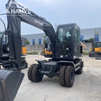 Pelle sur pneus Xinyuan C75W de 6,7 tonnes, bien entretenue, avec lame de bouteur avant, performances stables pour le creusement, garantie incluse
