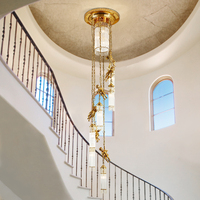 Lustre long européen en laiton de luxe avec pendentifs en cristal français pour escalier, luminaire suspendu en grappe