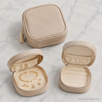 Étui de voyage beige pour bijoux avec fermeture éclair, anneau de traction à pompon et poche intérieure