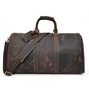 Combinando elegancia y resistencia, esta bolsa de viaje 100% de cuero genuino ofrece gran capacidad de almacenamiento y un rendimiento duradero. - Product Image 2
