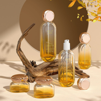 Ensemble de produits de soin de la peau haut de gamme, flacon en verre ovale 30 ml 50 ml, flacon d'essence avec tête de pompe 30 g 50 g, pot à crème avec couvercle doré