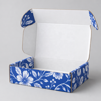 Boîte d'emballage personnalisée en carton ondulé bleu royal et blanc avec logo floral botanique pour cosmétiques, cadeaux et abonnements