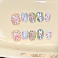 Ongles press-on faits main style niche, couleur macaron, motifs cœurs et nœuds, finition poudre miroir magique, lignes blanchissantes, amovibles