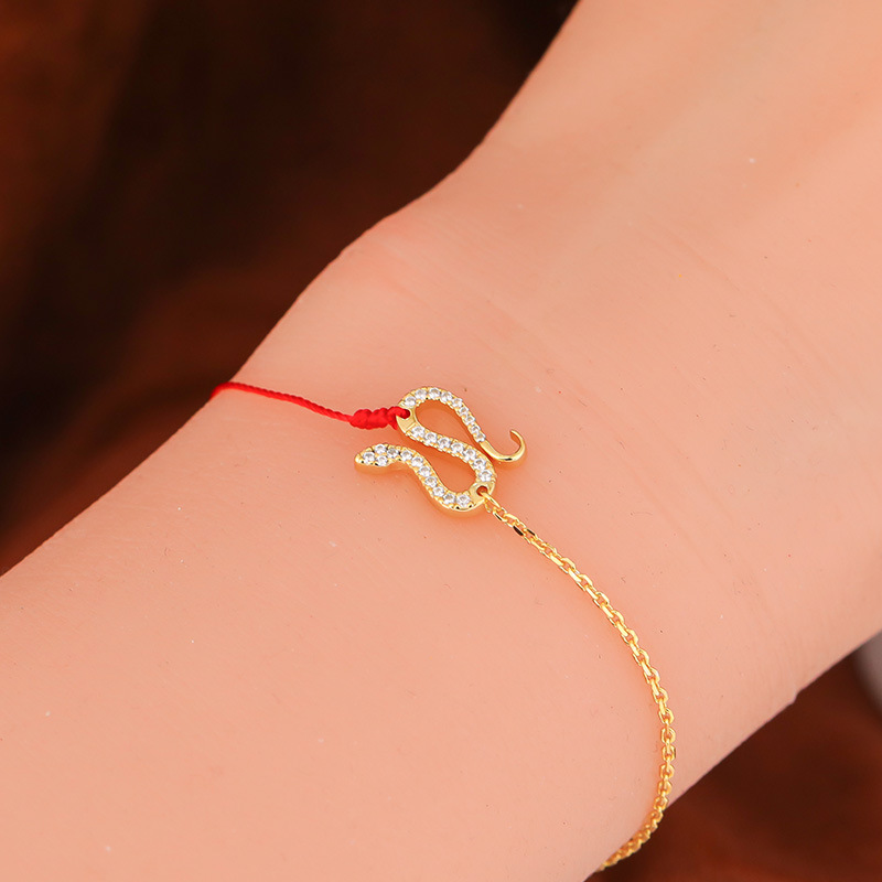 Bracelet serpent fil rouge doré