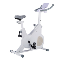 Vélo d'exercice à domicile blanc avec transmission par courroie magnétique, support pour tablette et porte-gobelet pour un entraînement cardio confortable en intérieur