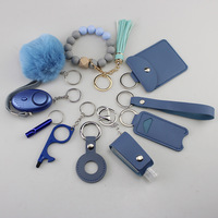 Ensemble de porte-clés de sécurité promotionnels en gros Alarme personnelle Pom Pom Ball Bracelet en silicone DIY 11PCS Ensemble de porte-clés d'autodéfense