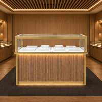 Vitrine îlot en acier inoxydable à grain de bois avec finition dorée et éclairage LED pour bijoux, parfums, cosmétiques, showroom, vente en gros