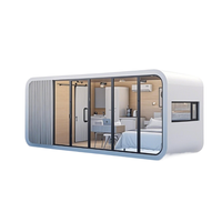 Maison conteneur modulaire en acier pliable moderne, type Apple Cabin, utilisable comme hôtel, entrepôt, bureau ou logement.