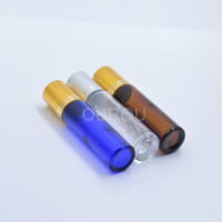 Flacon roll-on cosmétique en verre ambré bleu non transparent de 15 ml, avec bille métallique dorée estampée et sérigraphiée, diffuseur rectangulaire