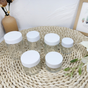 Tarro redondo de vidrio de grado alimenticio certificado CR de 1oz con tapa a prueba de niños para uso doméstico o cocina comercial - Product Image 1