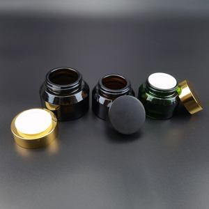 Tarro de vidrio redondo de 50g/100g transparente/negro/verde/azul con hombro inclinado y tapa de plástico dorada/negra - Product Image 5