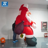 Père Noël gonflable géant personnalisé avec sac à dos pour la décoration de centres commerciaux en extérieur lors des événements de Noël