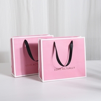 Cadeau de luxe de haute qualité à utiliser en magasin Sacs d'emballage en papier personnalisés avec logo imprimé pour vêtements avec corde à ruban