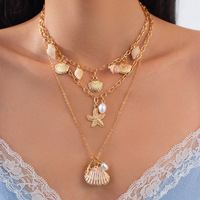 Collier pour femme en or 14 carats, style bohème, multi-couches, avec pendentifs étoile de mer, coquillage, conque et perles d'imitation, chaîne de clavicule haut de gamme