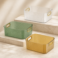 Panier de rangement transparent haut de gamme avec poignées dorées et design empilable pour maquillage, cosmétiques et articles de toilette
